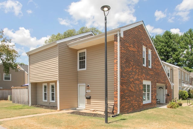 back of house featuring a yard