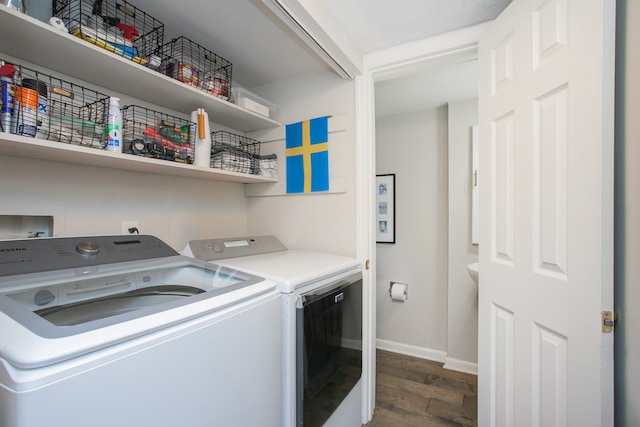 washroom with washer and dryer and dark hardwood / wood-style flooring