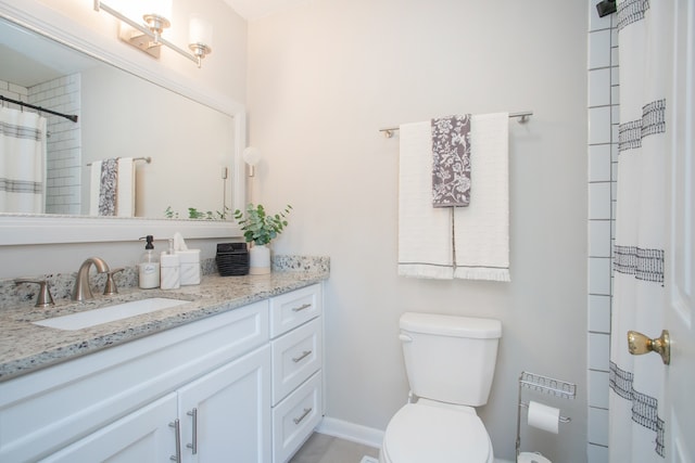 bathroom featuring curtained shower, vanity, and toilet