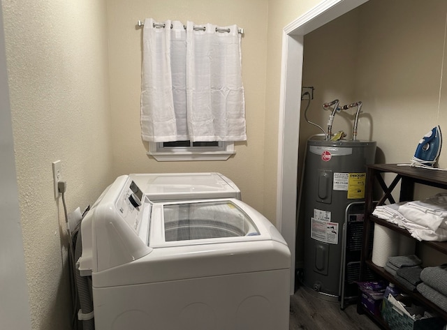 laundry area featuring washer and dryer, hardwood / wood-style flooring, and water heater