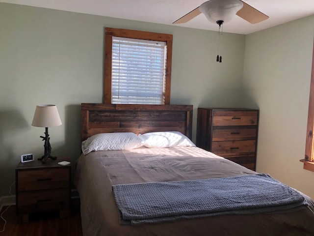 bedroom featuring ceiling fan and dark wood-type flooring