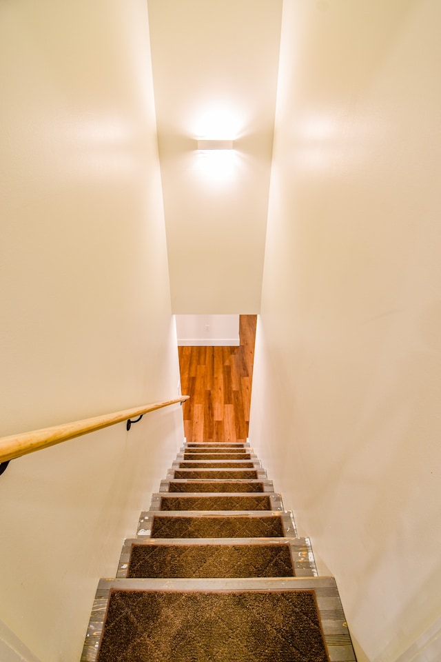 stairway with hardwood / wood-style flooring