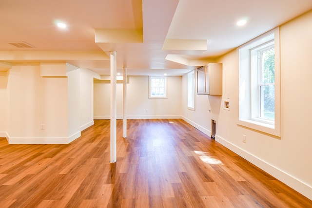 basement with light hardwood / wood-style floors