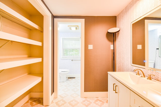 bathroom featuring tile patterned floors, toilet, and vanity