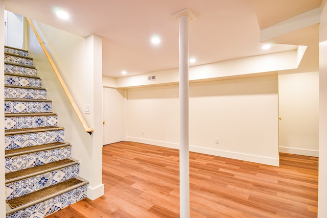 basement featuring hardwood / wood-style floors