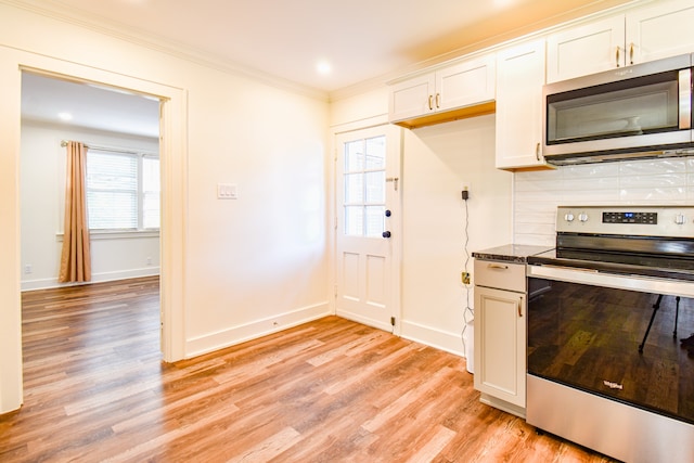 kitchen with a wealth of natural light, stainless steel appliances, and light wood-type flooring