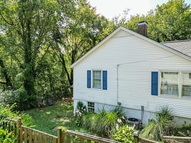 view of side of home featuring a lawn