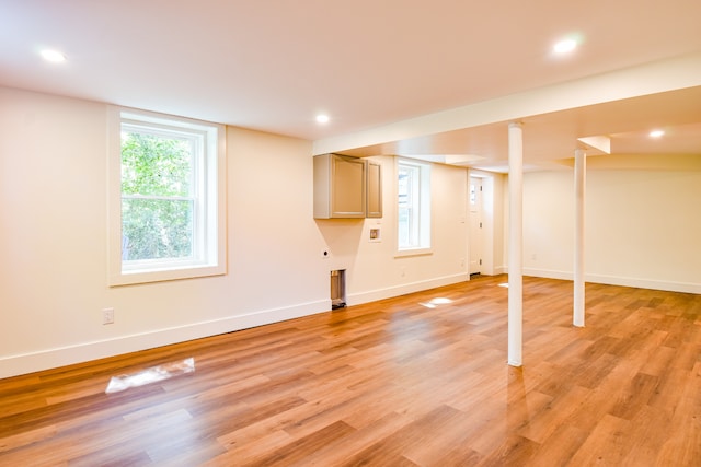 basement with light hardwood / wood-style flooring