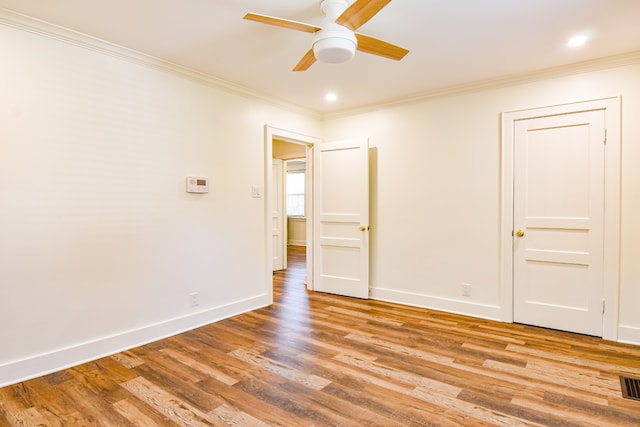 unfurnished bedroom featuring ceiling fan, crown molding, and light hardwood / wood-style flooring