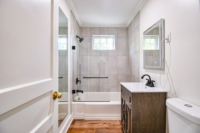 full bathroom featuring hardwood / wood-style flooring, toilet, vanity, and ornamental molding