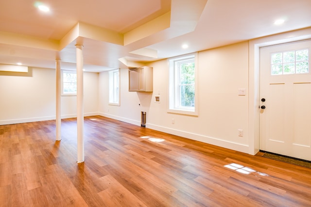 basement with light hardwood / wood-style flooring