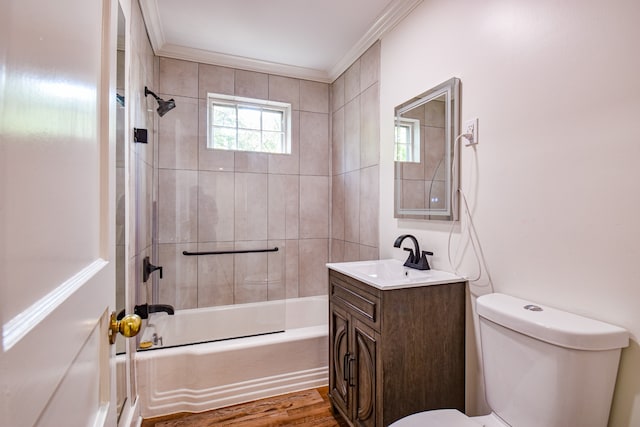 full bathroom with toilet, vanity, hardwood / wood-style flooring, crown molding, and tiled shower / bath