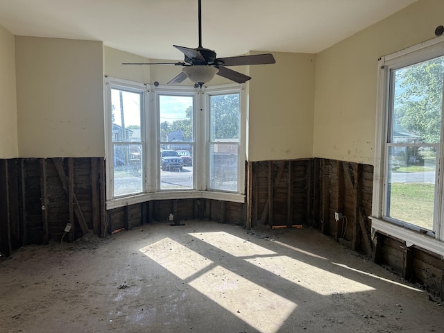 spare room with a sunroom and a healthy amount of sunlight