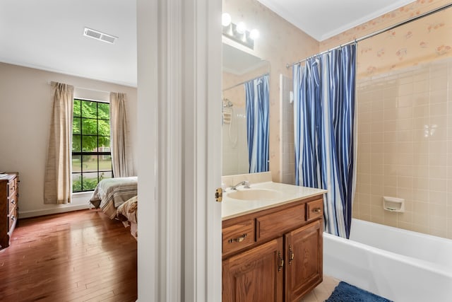 bathroom with ornamental molding, vanity, hardwood / wood-style flooring, and shower / bath combo with shower curtain