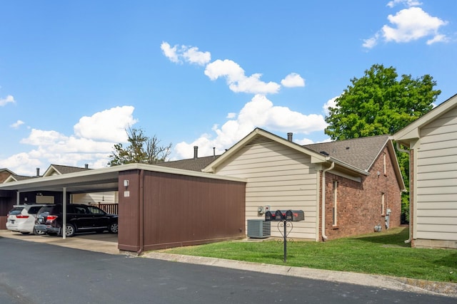 710 General George Patton Rd, Nashville, TN 37221 - view of home's exterior featuring a lawn, brick siding, cooling unit, and covered parking