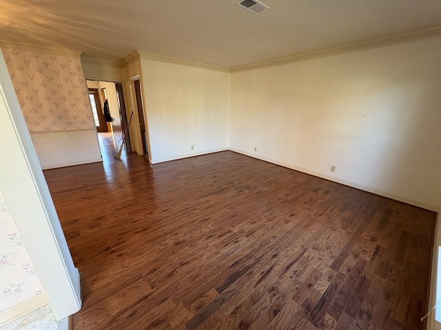 unfurnished room featuring crown molding and dark wood-type flooring