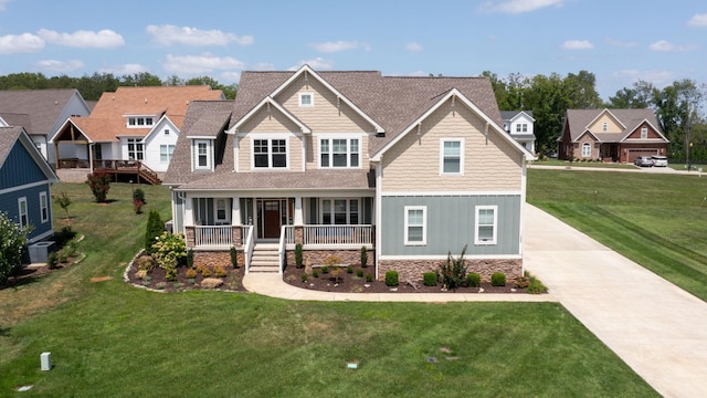 craftsman house with a residential view, a porch, a front yard, and board and batten siding