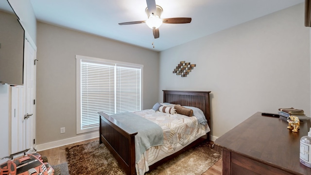 bedroom with ceiling fan and light hardwood / wood-style floors