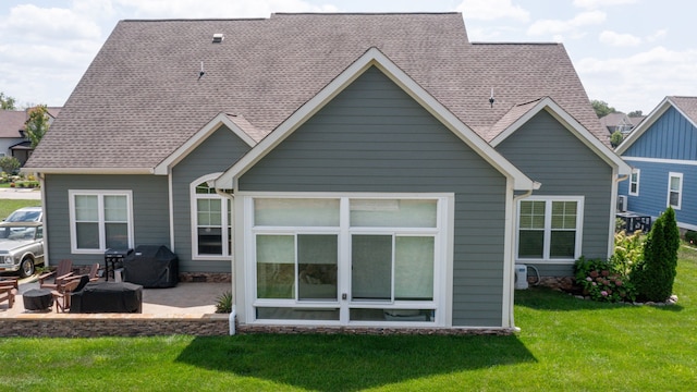 rear view of property with a lawn and a patio