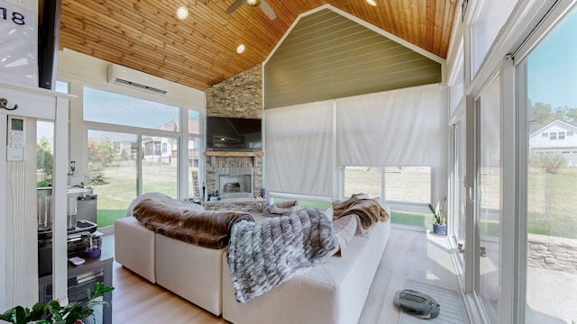 sunroom / solarium featuring a fireplace, lofted ceiling, an AC wall unit, and wood ceiling