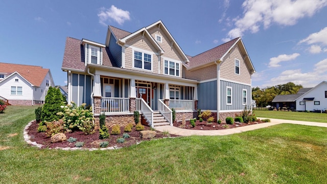 craftsman-style house with board and batten siding, a porch, a front yard, and a shingled roof