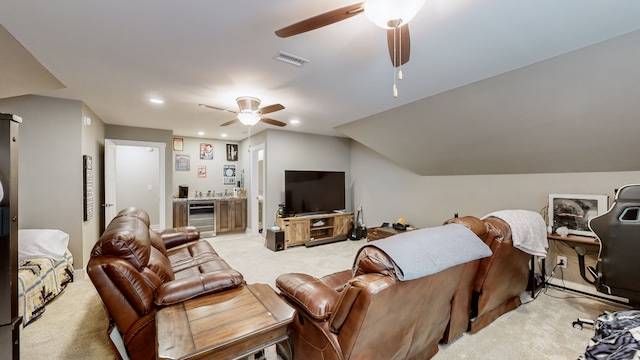 living room featuring ceiling fan, vaulted ceiling, light carpet, and beverage cooler