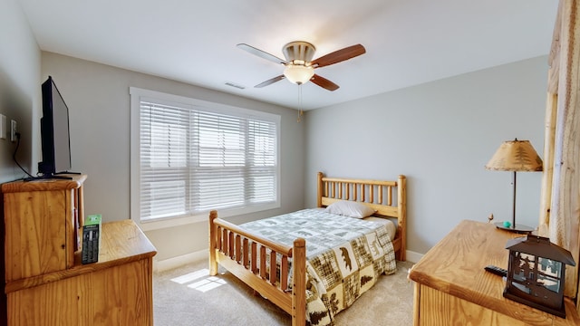 bedroom with ceiling fan, multiple windows, and light colored carpet