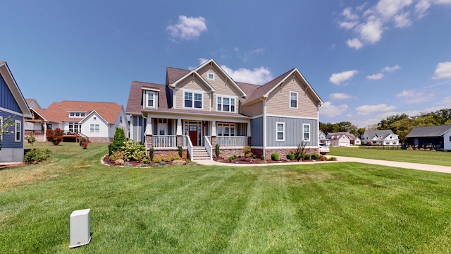 craftsman-style home featuring a front yard and covered porch