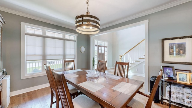 dining space with stairway, baseboards, light wood finished floors, ornamental molding, and a notable chandelier