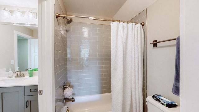 full bathroom with toilet, vanity, and shower / tub combo