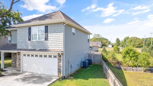 view of side of property featuring a yard and a garage