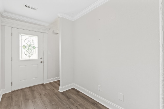 foyer entrance with ornamental molding and hardwood / wood-style flooring