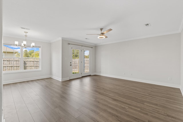 empty room featuring hardwood / wood-style floors, ceiling fan with notable chandelier, and crown molding