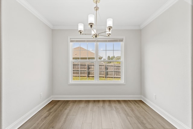 unfurnished dining area with ornamental molding, light hardwood / wood-style flooring, and a notable chandelier