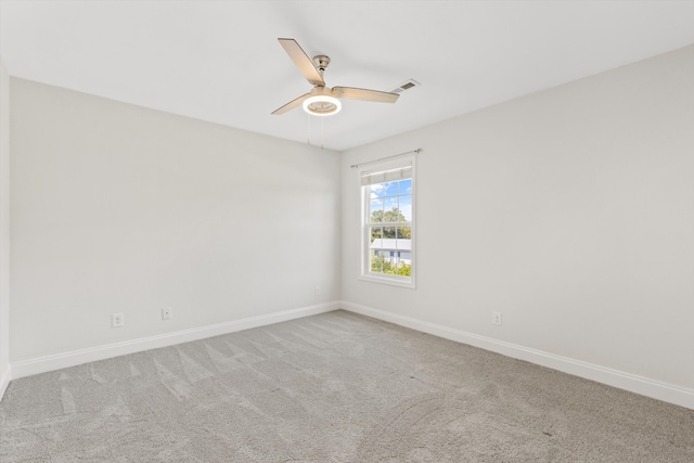 spare room featuring ceiling fan and light carpet