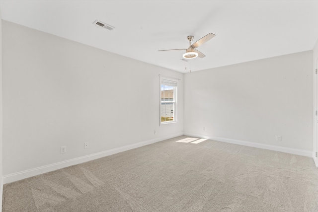 unfurnished room featuring light carpet and ceiling fan