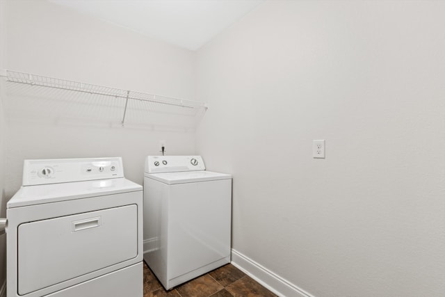 laundry room with dark tile patterned flooring and independent washer and dryer