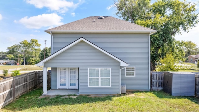 rear view of house featuring a yard