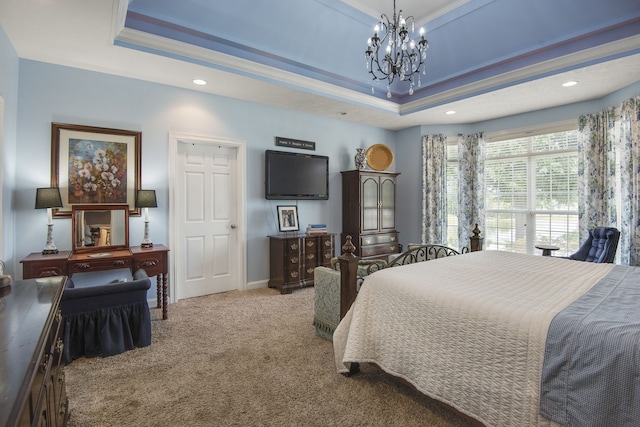 bedroom featuring carpet, crown molding, a tray ceiling, and a chandelier