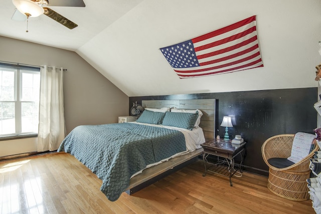 bedroom featuring ceiling fan, vaulted ceiling, and light wood-type flooring