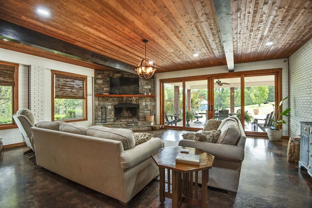 living room featuring a fireplace, plenty of natural light, a notable chandelier, and wooden ceiling