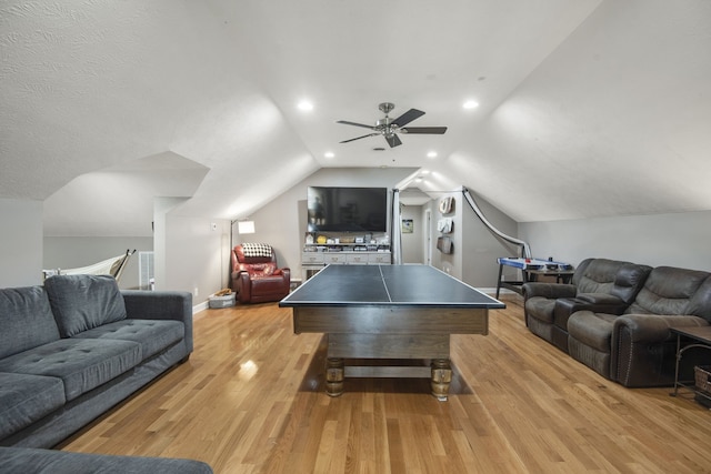 game room featuring light wood-type flooring, vaulted ceiling, and ceiling fan