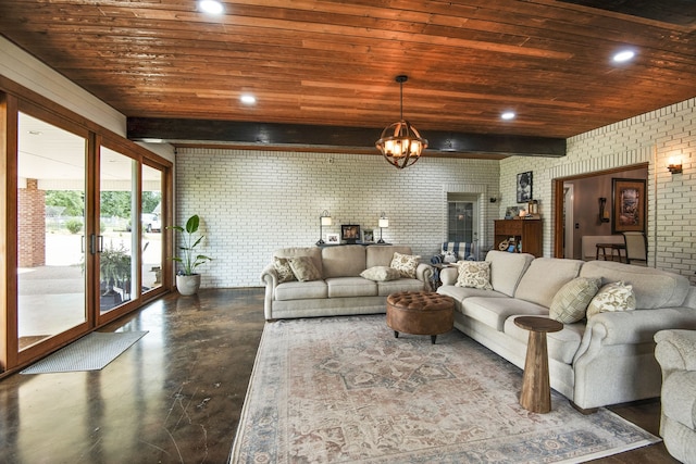 living room featuring beamed ceiling, wood ceiling, brick wall, concrete floors, and an inviting chandelier