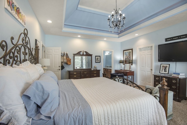 bedroom featuring carpet flooring, an inviting chandelier, and a tray ceiling