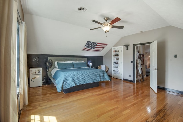 bedroom featuring ceiling fan, vaulted ceiling, and light hardwood / wood-style flooring