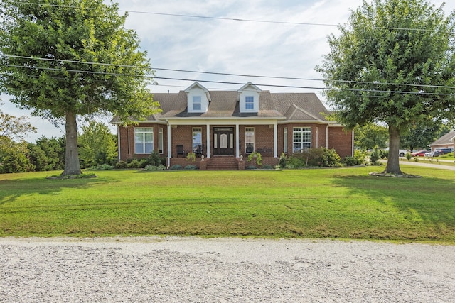 cape cod home featuring a front lawn and a porch