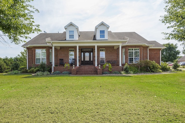 new england style home featuring a front yard and a porch