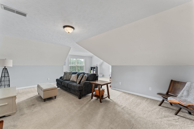 living room with light carpet, baseboards, and visible vents