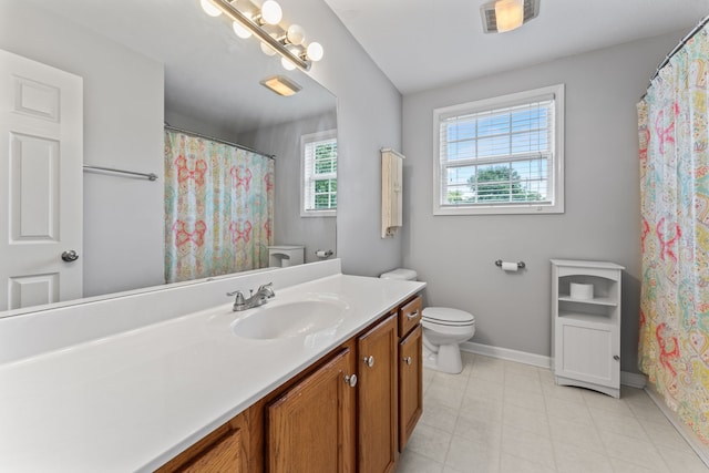 bathroom featuring tile patterned floors, vanity, and toilet