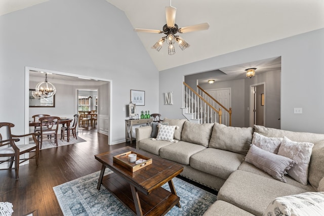 living room with ceiling fan with notable chandelier, dark hardwood / wood-style floors, and high vaulted ceiling